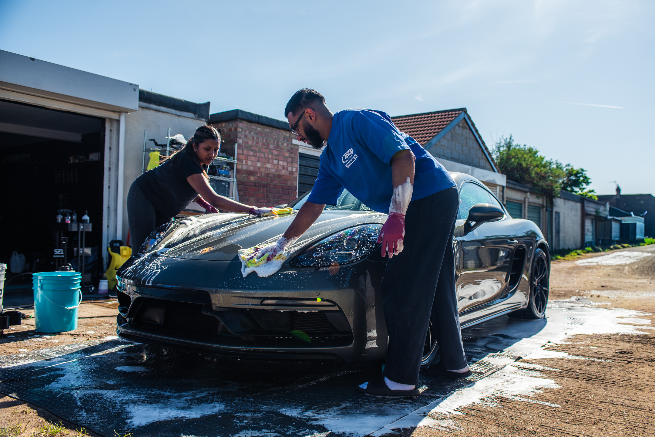 S21 team washing a Porsche Cayman GTS
